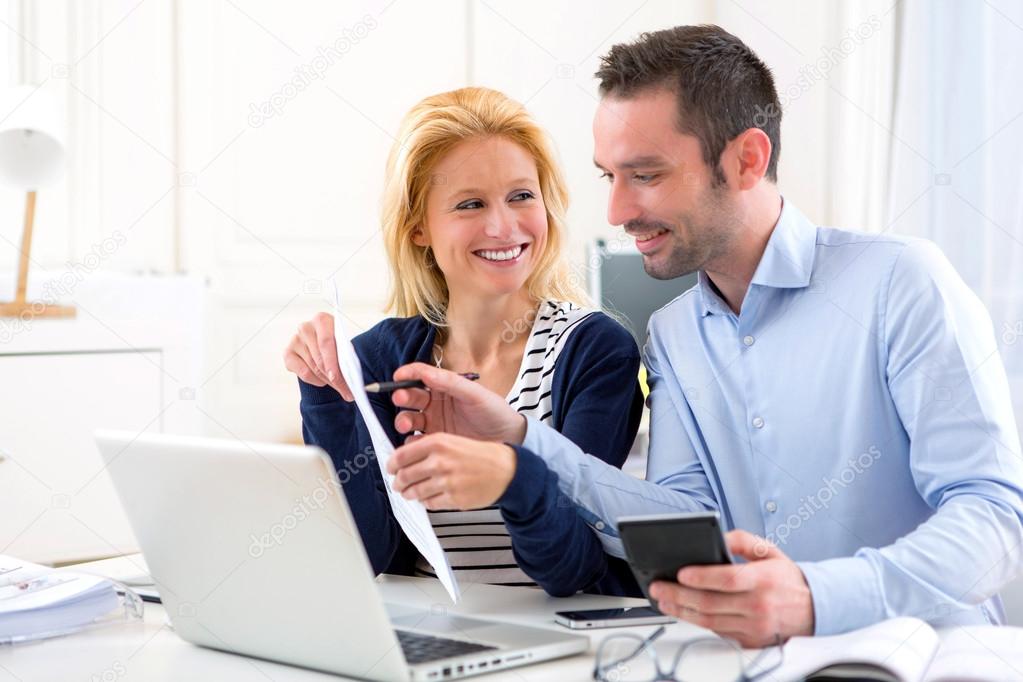 Attractive couple doing administrative paperwork