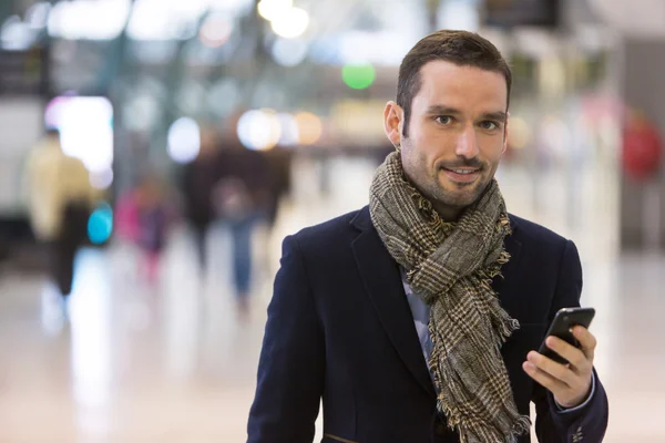 Young attractive man transiting a railway station — Stock Photo, Image