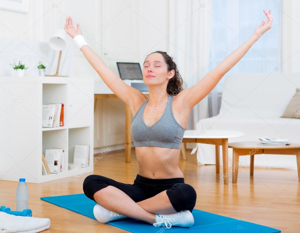 Young attractive woman stretching after sport