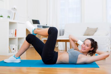 Evde egzersiz yaparak genç çekici kız