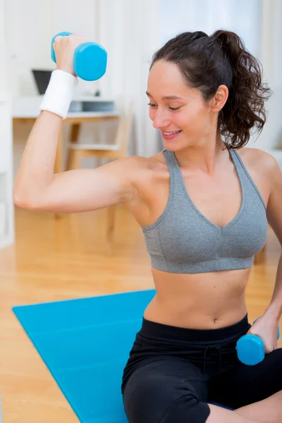 Young attractive girl doing exercise at home — Stock Photo, Image