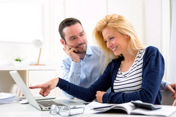 Junges attraktives Paar benutzt Laptop zu Hause — Stockfoto