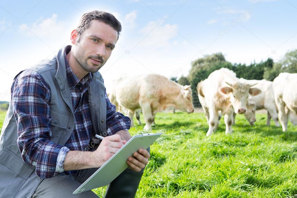 Young attractive farmer working in a field