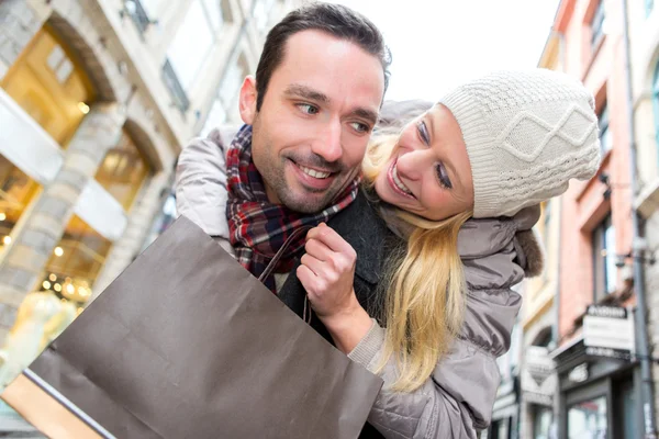 Jovem casal atraente se divertindo enquanto faz compras — Fotografia de Stock