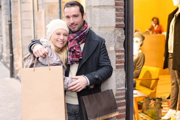 Young attractive couple with shopping bags — Stock Photo, Image