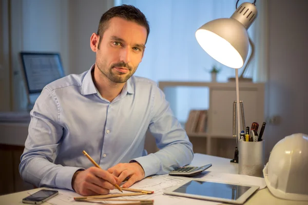 Young attractive architect working late at office — Stock Photo, Image