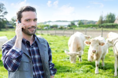 Bir alandaki cep telefonu kullanarak genç çekici çiftçi