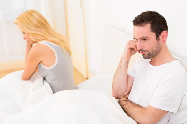 Joven pareja atractiva teniendo una discusión en la cama —  Fotos de Stock