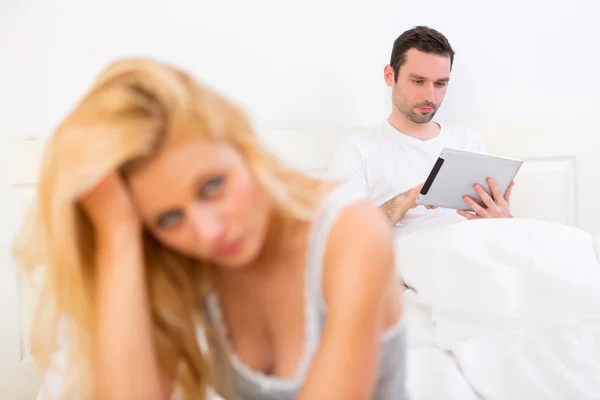 Young attractive couple having an argue in bed — Stock Photo, Image