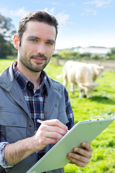 Young attractive farmer working in a field