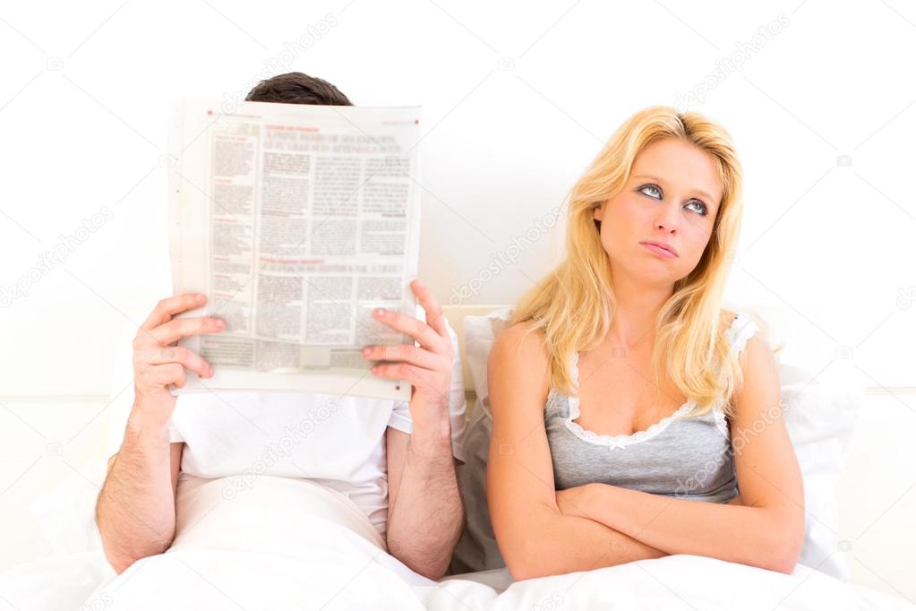 Young woman bored while her boy reading news