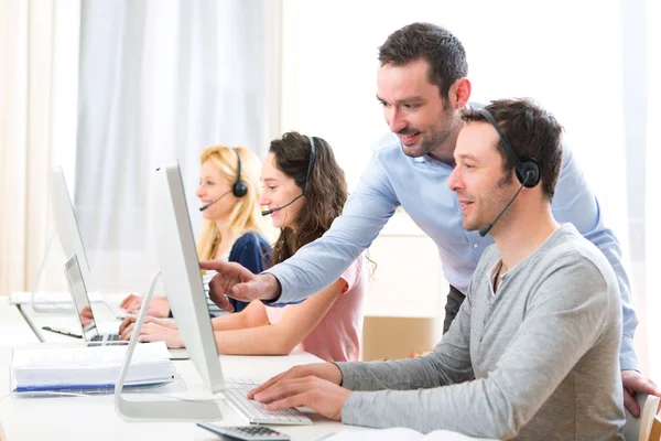 Manager training a young attractive people on computer — Stock Photo, Image