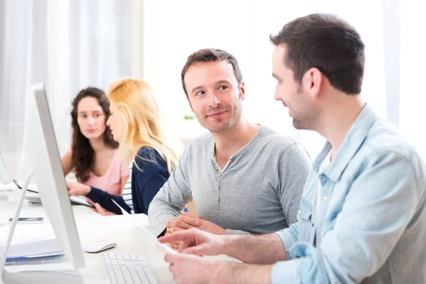 Young attractive people working together at the office — Stock Photo, Image