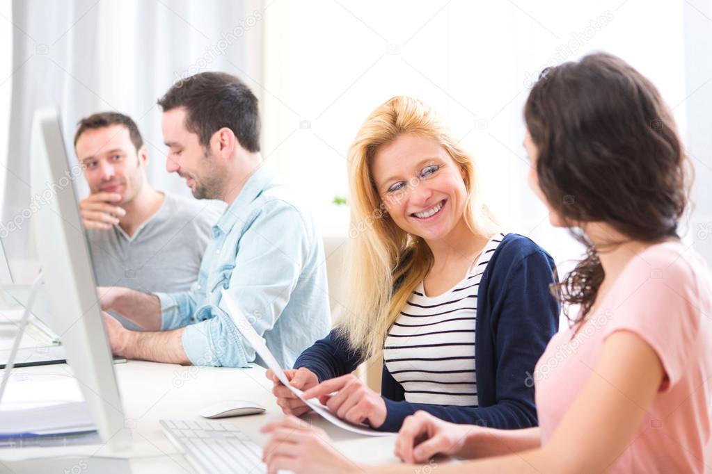 Young attractive people working together at the office 