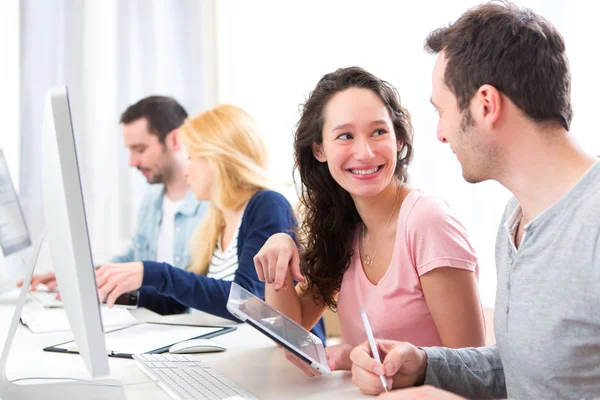 Young attractive people working together at the office — Stock Photo, Image