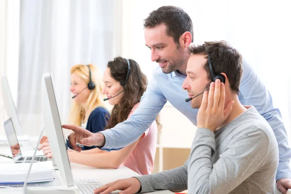 Manager training a young attractive people on computer — Stock Photo, Image