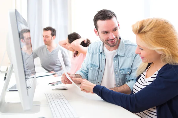 Young attractive people working together at the office — Stock Photo, Image