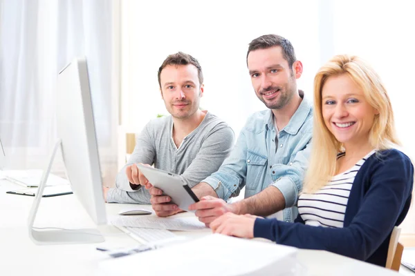 Young attractive people working together at the office — Stock Photo, Image