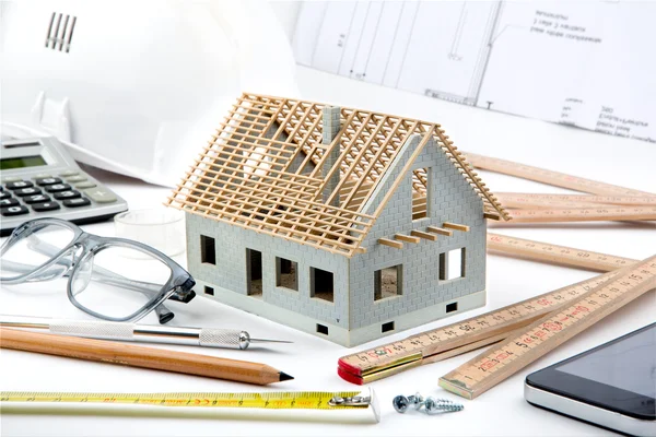 House miniature under construction on an architect desk — Stock Photo, Image