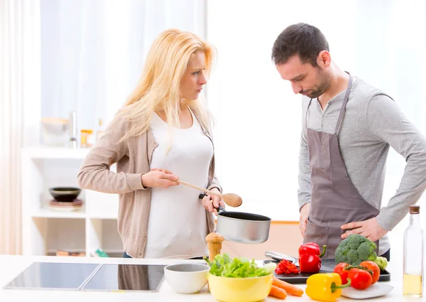 Young attractive couple having an argue while cooking — Stock Photo, Image