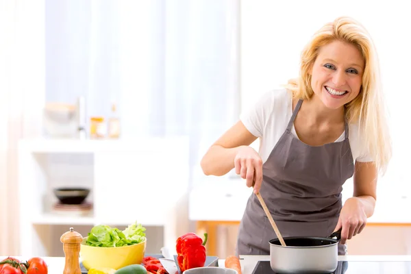 年轻漂亮的女性在厨房做饭 — 图库照片