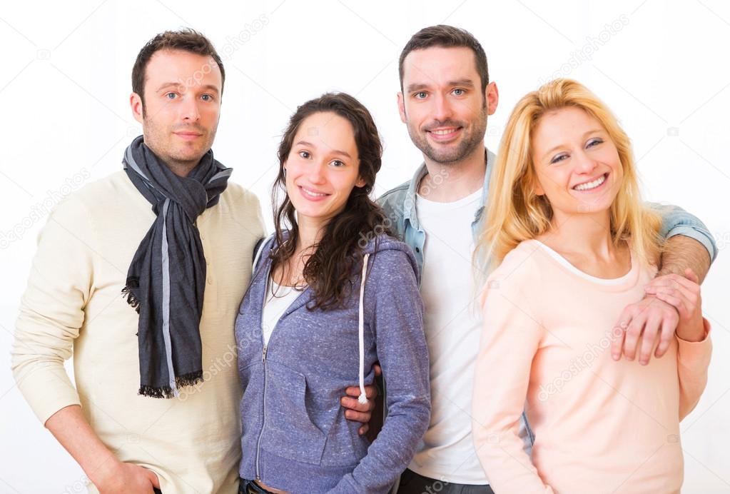 Group of 4 young attractive people on a white background