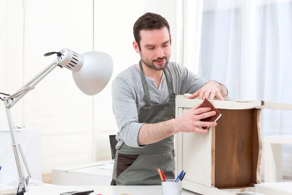 Young attractive carpenter working in his workshop — Stock Photo, Image