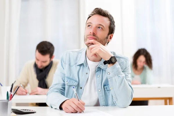 Young attractive student during exam — Stock Photo, Image