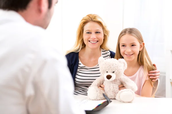 Little girl at the doctor with her mother