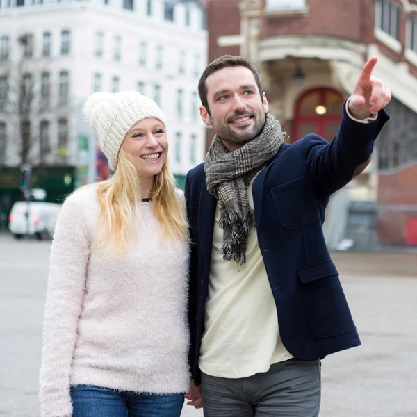 Young attractive couple on holidays in city — Stock Photo, Image