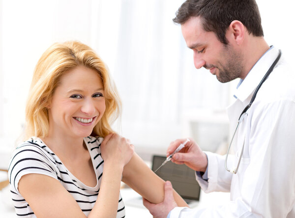 Young attractive woman being vaccinated Stock Picture