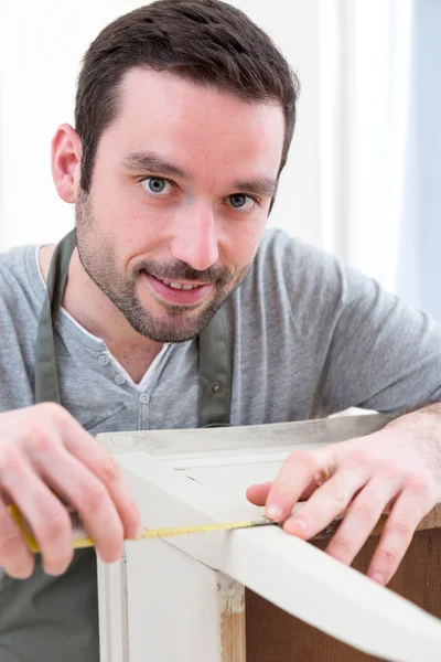 Young attractive carpenter working in his workshop — Stock Photo, Image