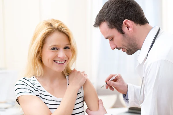 Young attractive woman being vaccinated — Stock Photo, Image