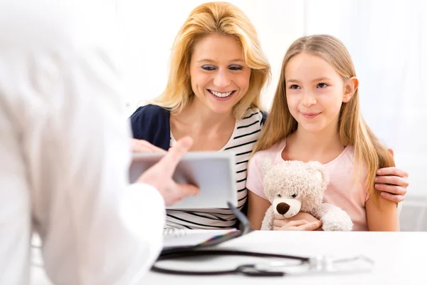 Little girl at the doctor with her mother