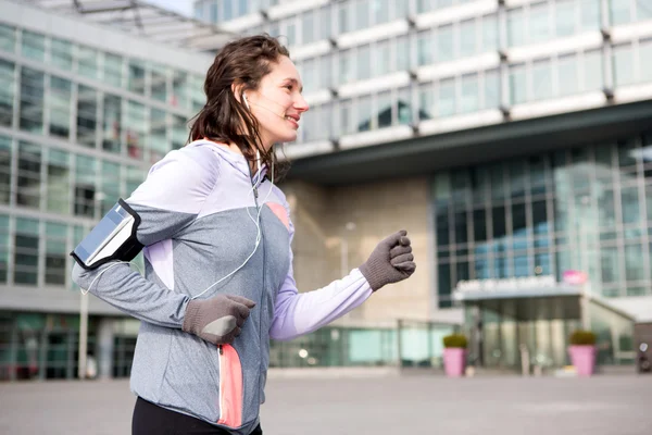 Young attractive woman running downtown — Stock Photo, Image