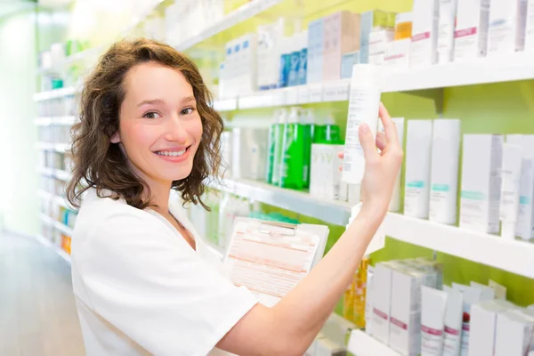 Attractive pharmacist clean the store up — Stock Photo, Image