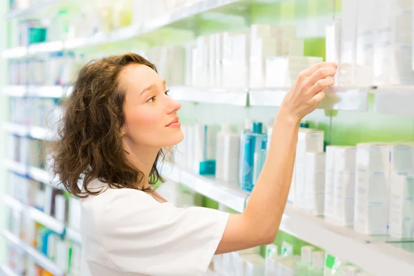 Attractive pharmacist clean the store up — Stock Photo, Image