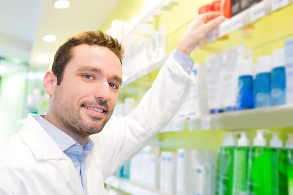 Attractive pharmacist clean the store up — Stock Photo, Image