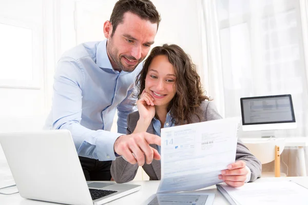 Young attractive couple doing paperwork — Stock Photo, Image