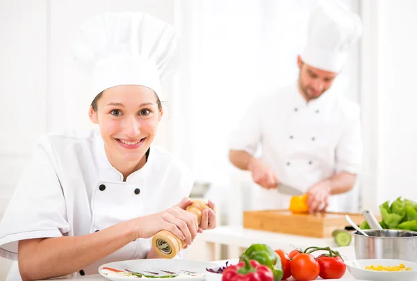 Young attractive professional chef cooking in his kitchen — Stock Photo, Image