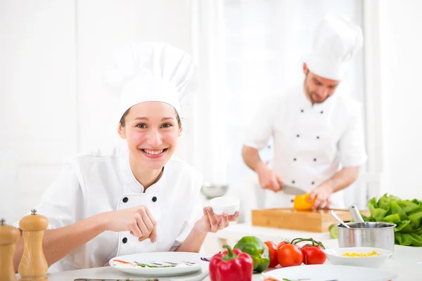 Young attractive professional chef cooking in his kitchen — Stock Photo, Image