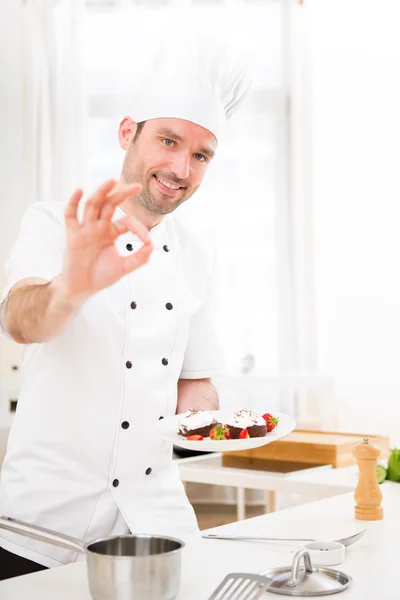 Young attractive professional chef cooking in his kitchen — Stock Photo, Image