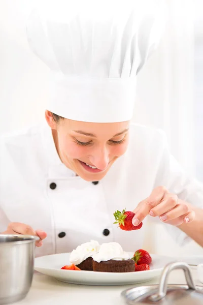 Young attractive professional chef cooking in his kitchen Stock Photo