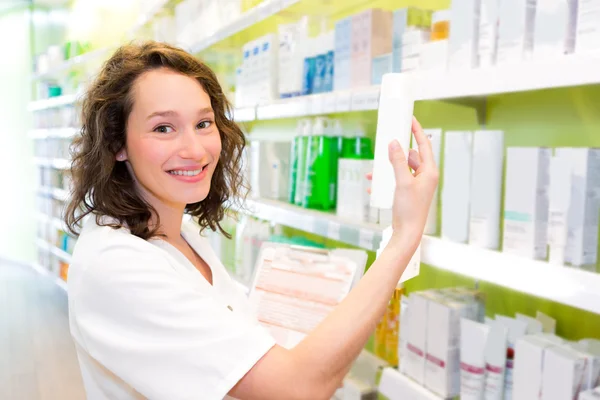 Attractive pharmacist clean the store up — Stock Photo, Image