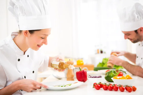 Young attractive professional chef cooking in his kitchen — Stock Photo, Image