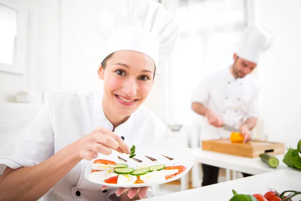 Young attractive professional chef cooking in his kitchen — Stock Photo, Image