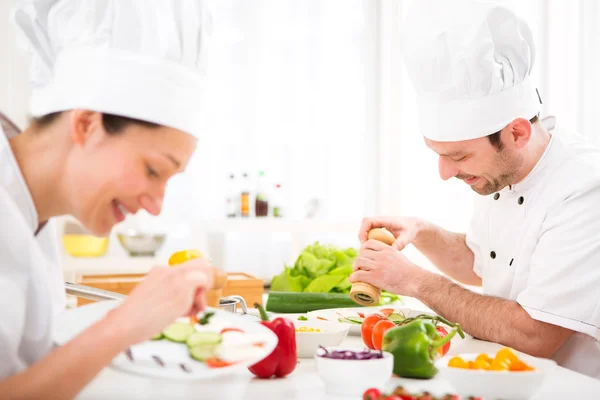 Young attractive professional chef cooking in his kitchen — Stock Photo, Image