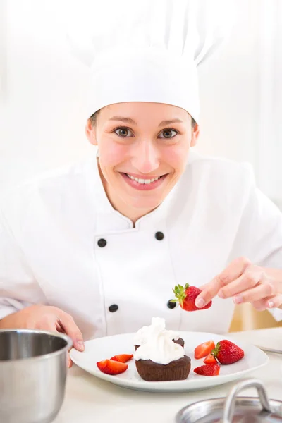 Giovane chef professionale attraente cucina nella sua cucina — Foto Stock