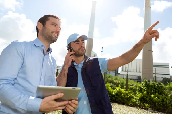 Electrician and engineer working together at the electric statio — Stock Photo, Image