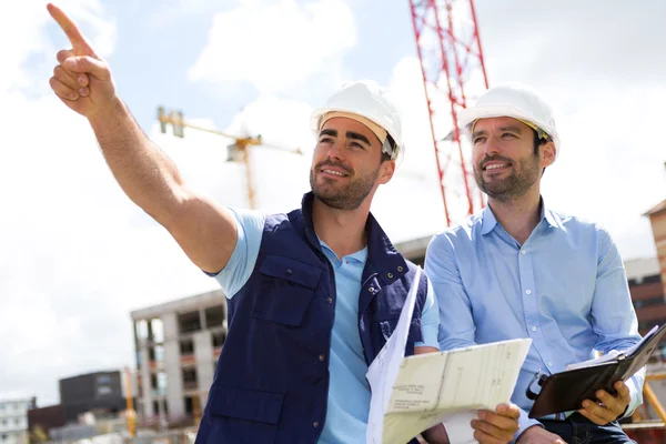 Worker and architect watching some details on a construction — Stock Photo, Image